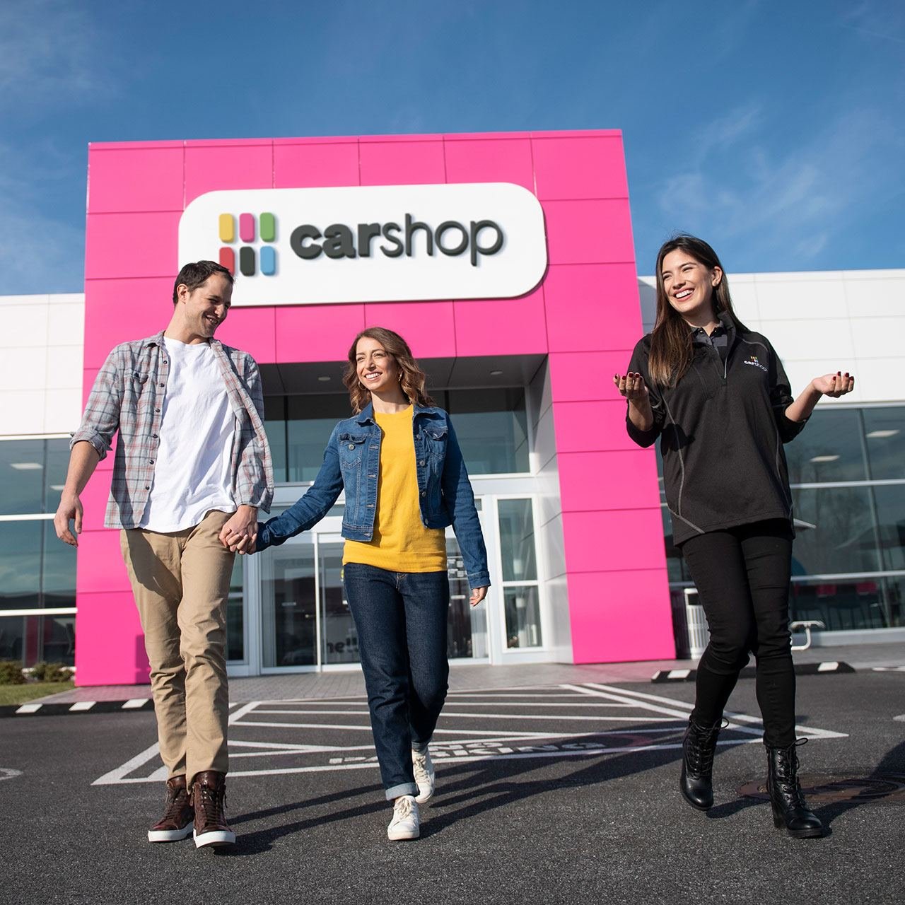 Couple shopping for a car with a salesperson